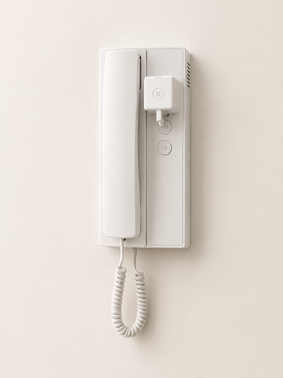 IntercomBot device mounted on a white handset intercom